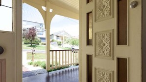 A door leading to a covered porch with a view of a residential neighborhood. - Lovely Family Home in South Launceston - Prime Location (South Launceston)