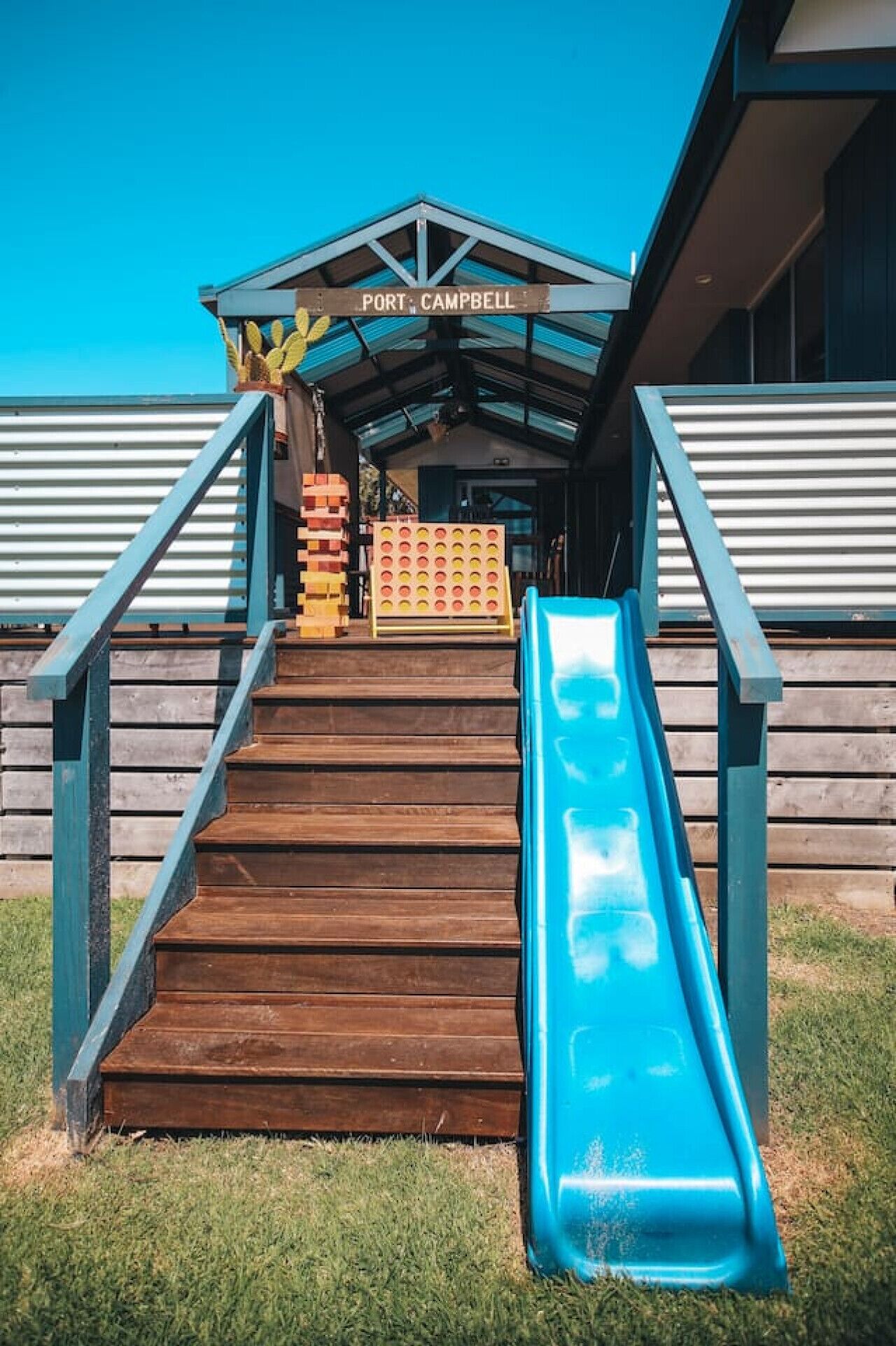 A wooden staircase leading to a building with a sign reading 'PORT CAMPBELL'.
