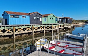 A waterfront property with a wooden dock and colorful buildings.