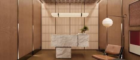 A modern interior with a reception desk, seating area, and a patterned ceiling.