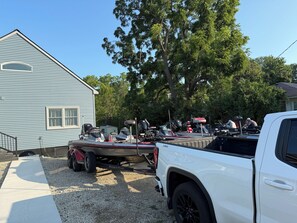 A white pickup truck with a boat trailer attached, parked on a gravel driveway. -     Balti Bay Loft -Beach & Boating Getaway Downtown New Baltimore  -Sleeps 11 (New Baltimore)
