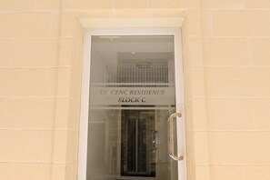 A building entrance with a sign reading 'TA CENC RESIDENCE BLOCK C'. - Pool And Sea - Modern Apart Sannat Gozo, Sannat Ghawdex - Gozo, Malta (Sannat Ghawdex - Gozo)