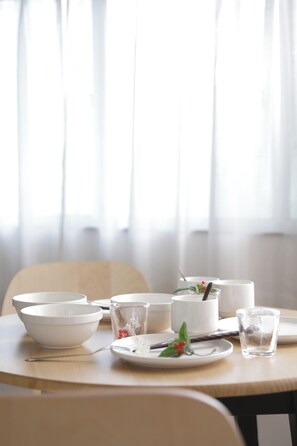 A dining table with white bowls, a glass, and a plate with a spoon and berries. - Neo Universal 01 (Osaka, Konohana, Nishikujo)