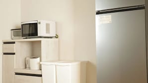 A compact kitchen with a microwave, kettle, and a refrigerator. - Neo Universal 01 (Osaka, Konohana, Nishikujo)