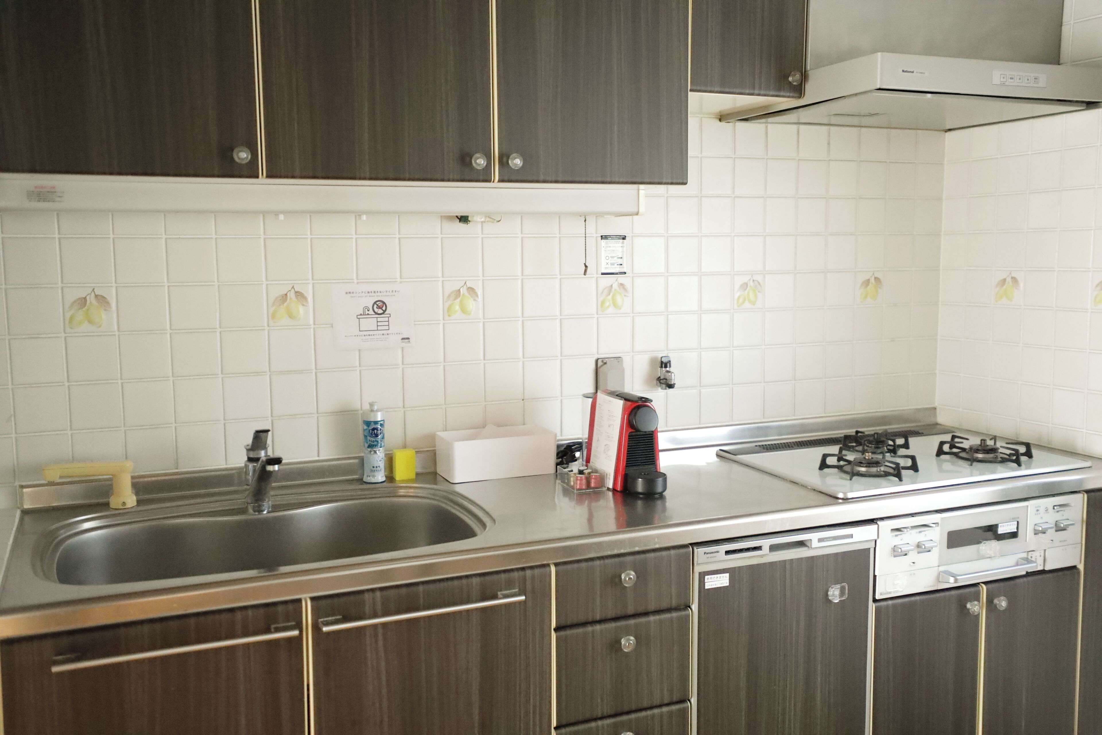 A kitchen with stainless steel appliances, a gas stove, a dishwasher, and wooden cabinets.