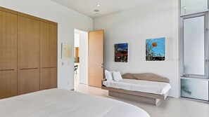 A bedroom with a large bed, a wooden wardrobe, a bedside table, and two wall-mounted paintings. - The Malibu Art Estate by Avantstay Infinity Pool + Theater + Game Room 20 Private Acres (Malibu)