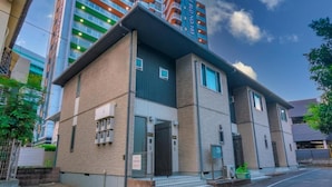 A modern building with a flat roof, large windows, and a visible entrance. - Best Friend (Fukuoka City Hakataku Katakasu)