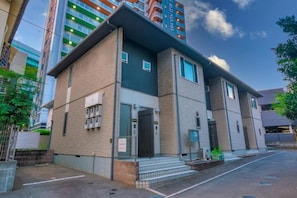 A modern building with a flat roof, large windows, and a visible entrance. - Best Friend (Fukuoka City Hakataku  Katakasu)