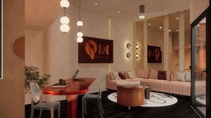 A modern interior with a sofa, a round table, and pendant lighting. - PIN GEM Boutique (Ho Chi Minh City)