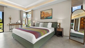 A modern hotel room with a large bed, a desk, a chair, a nightstand, a lamp, a painting, and a large mirror.