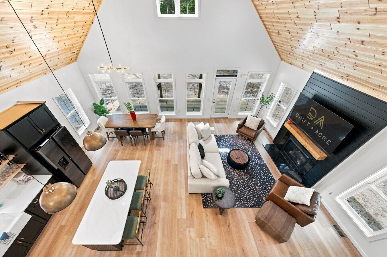 A modern loft-style living space with a kitchen, dining area, and seating area.