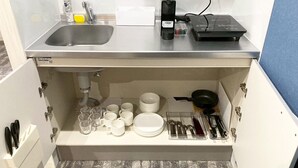 A compact kitchen with a sink, a coffee maker, and a portable heater on the countertop. - Neo Universal 02 (Osaka, Konohana Ward, Nishikujo)