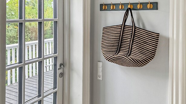 A door with a view of a wooden deck, a wall-mounted coat rack with hooks, and a power outlet. - 4 bedroom gorgeous home in Karrebæksminde (Karrebæksminde)