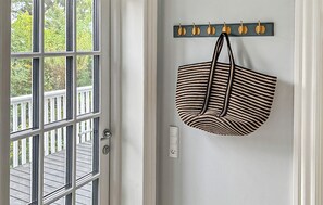 A door with a view of a wooden deck, a wall-mounted coat rack with hooks, and a power outlet. - 4 bedroom gorgeous home in Karrebæksminde (Karrebæksminde)