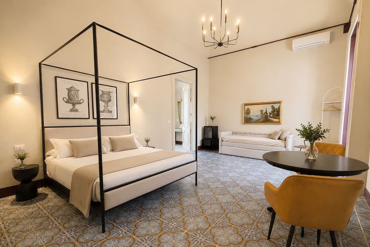Deluxe Quadruple Room | In-room safe, desk, laptop workspace, blackout curtains
