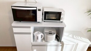 A kitchenette with a microwave, toaster, and kettle. - Neo Universal 05 (Osaka, Konohana, Nishikujo)