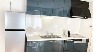 A modern kitchen with a refrigerator, sink, dishwasher, and cabinets. - Neo Universal 05 (Osaka, Konohana, Nishikujo)
