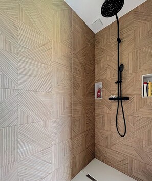A shower with a black handheld showerhead and a wall-mounted control panel. - Villa nestled between the mountains and the Basque Country (Sauvagnon)