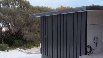 A modern building with a flat roof and a power outlet on the side.