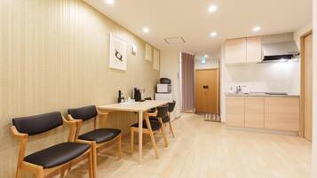 A modern kitchen with a dining area.