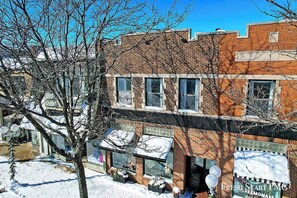 A brick building with multiple windows and a storefront. - Downtown Lakeview Loft w/ Free Parking & WiFi (St. Joseph)