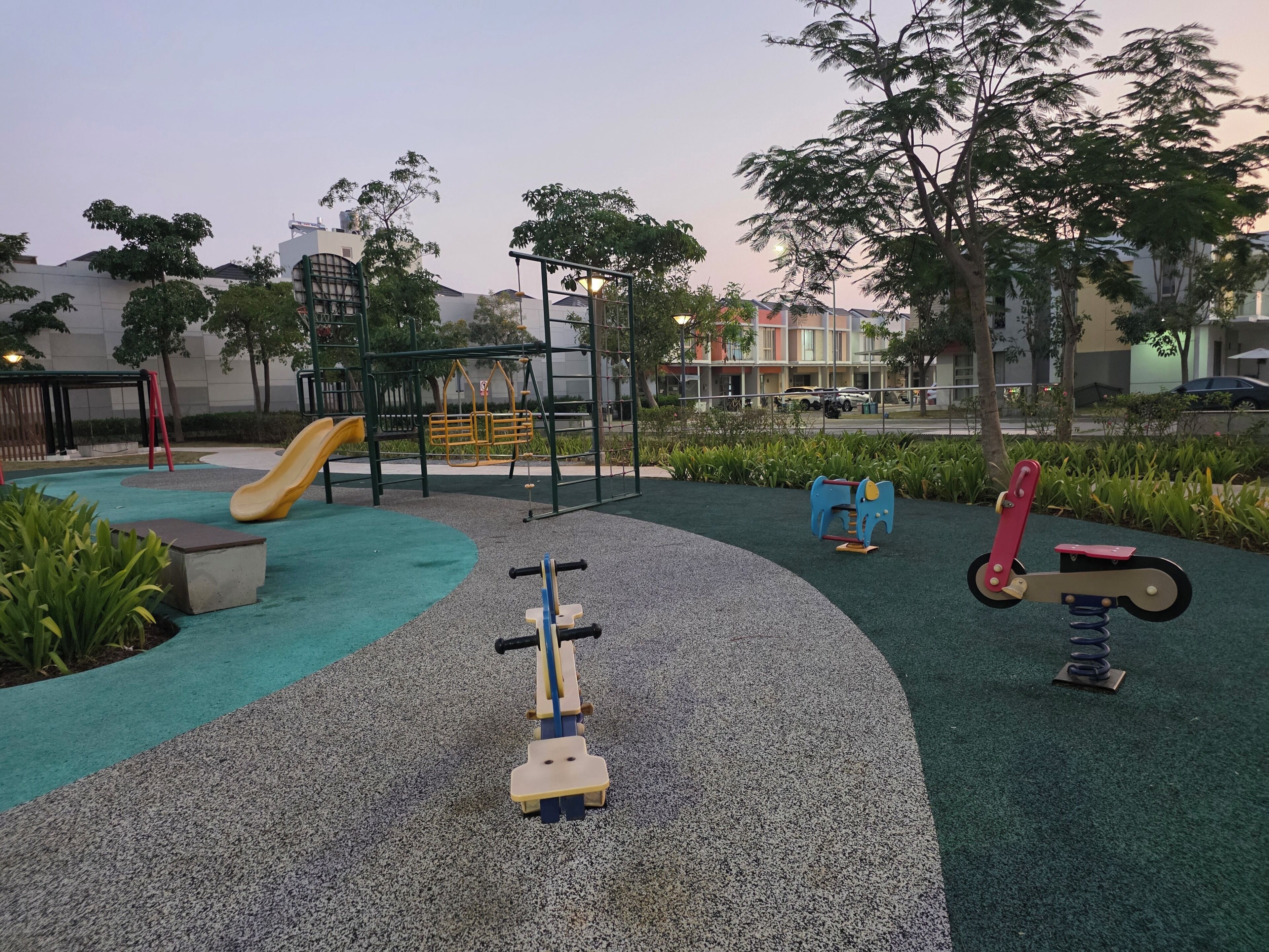 A playground with a slide, climbing structures, and exercise equipment.