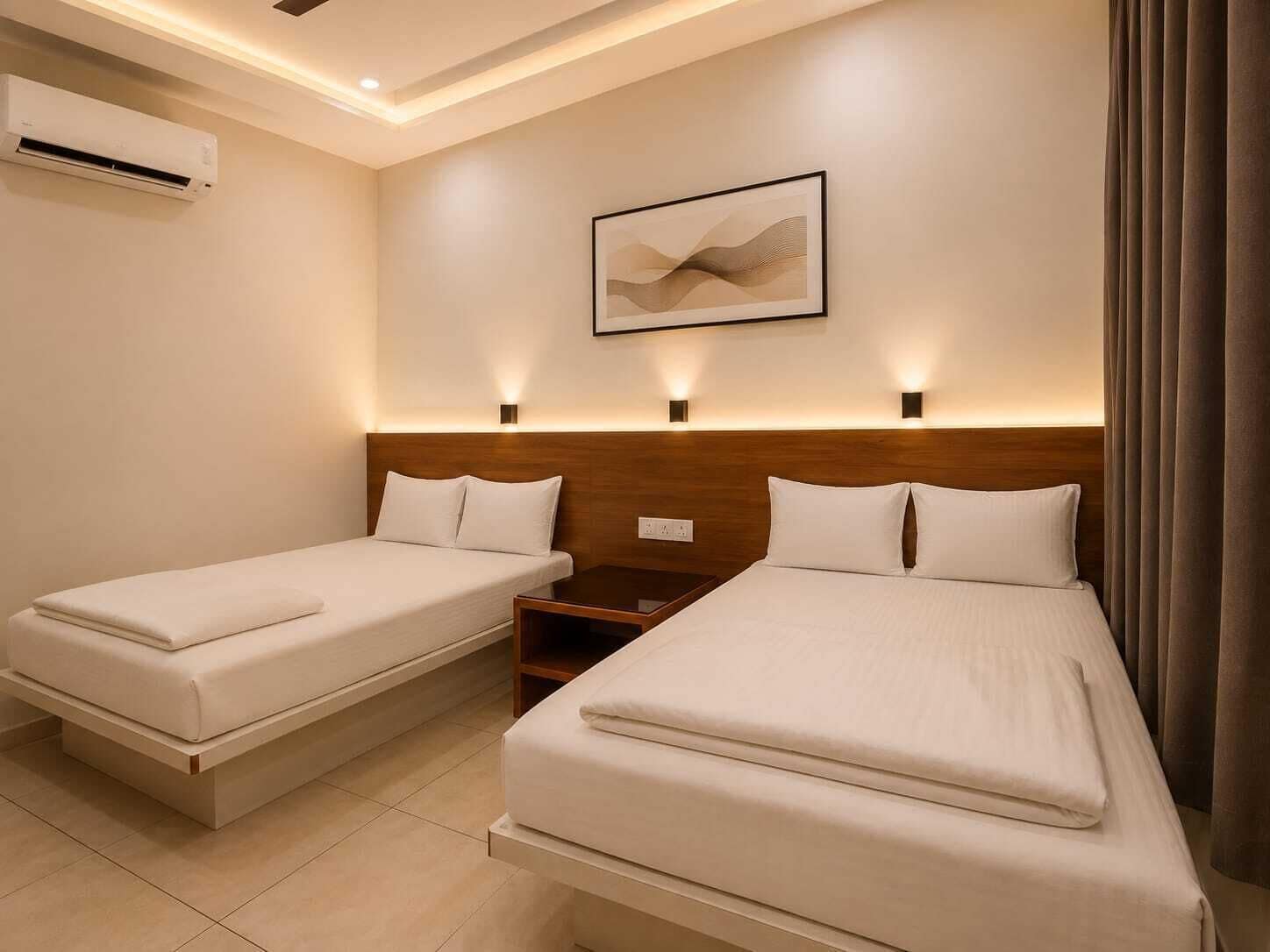 A hotel room with two single beds, a wooden headboard, a nightstand, and a wall-mounted air conditioner.