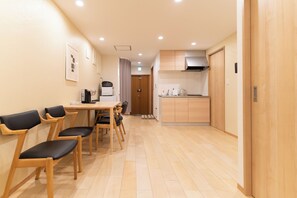 A modern kitchen with wooden cabinets, a microwave, and a stove.