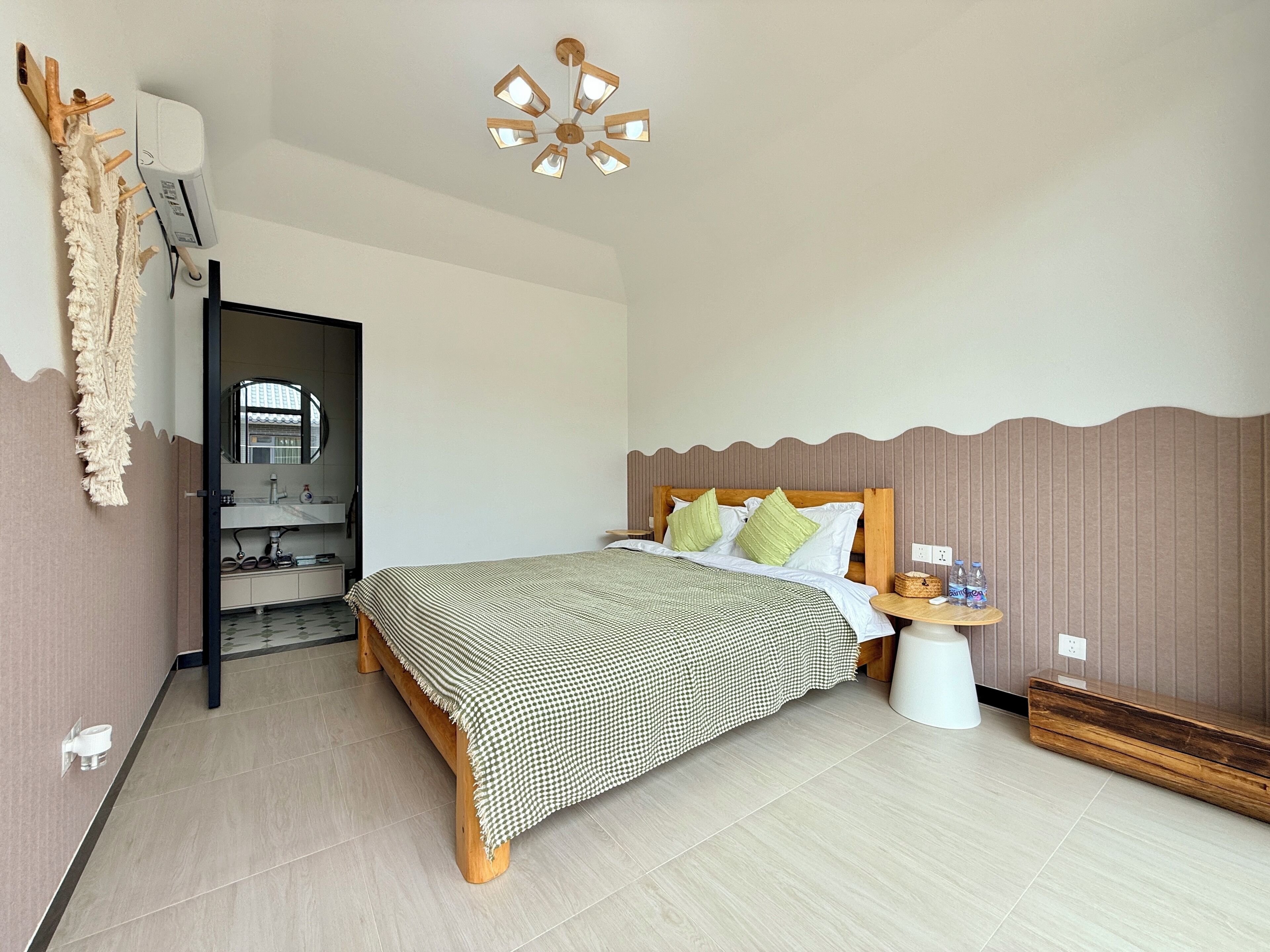 A bedroom with a bed, bedside table, and a ceiling fan.