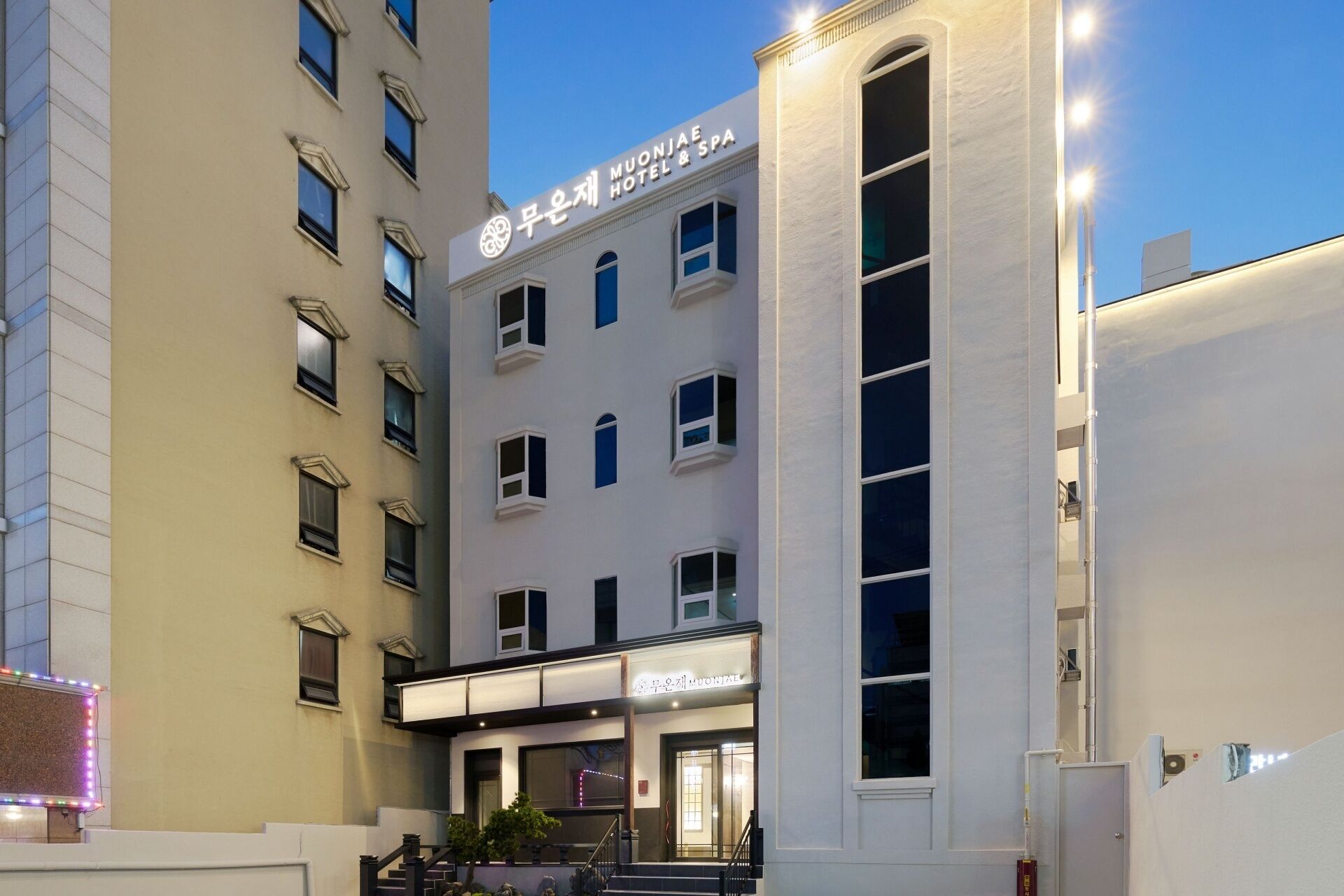 A hotel with a modern facade, multiple windows, and a sign indicating it is a hotel and spa.