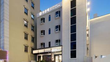 A hotel with a modern facade, multiple windows, and a sign indicating it is a hotel and spa.