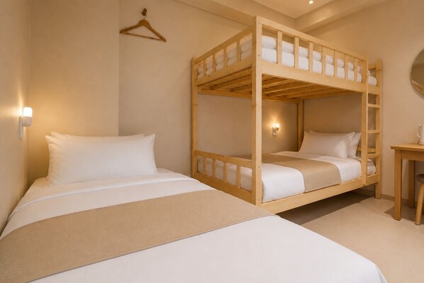 A bunk bed room with a wooden frame, a bedside table, and a wall-mounted light fixture.