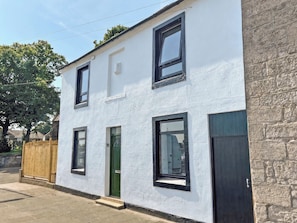 A two-story building with a white exterior and black-framed windows. - 3 bedroom accommodation in Tweedmouth (Tweedmouth)