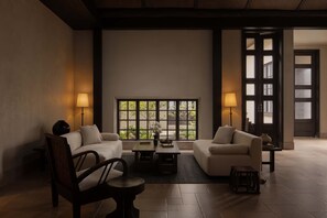 A modern living room with two sofas, a coffee table, and two floor lamps.