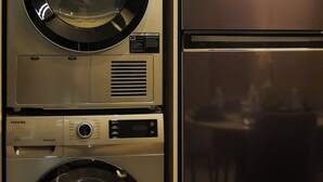 A compact kitchen with a stainless steel refrigerator and a built-in washer and dryer. - Imperial Residence KLCC- JD Home (Wilayah Persekutuan)
