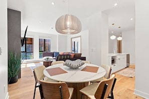 A modern dining area with a round table, chairs, and a pendant light. - Modern Mont-Tremblant Getaway -Ostrya (Mont-Tremblant)