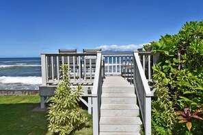 A wooden staircase leading to a deck with chairs, overlooking the ocean. - Garden View Condo Just Steps from the Ocean -Maui Sands Seaside 717 (Lahaina)