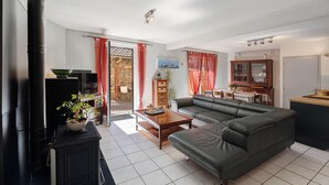 A living room with a sofa, a coffee table, a television, and a fireplace.