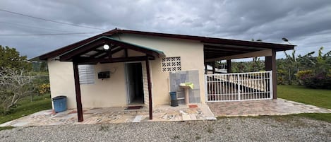 Un petit bâtiment doté d’une entrée abritée, d’une fenêtre et d’une porte.