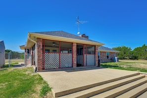 A single-story house with a porch, a chimney, and a satellite dish. - Swim, Grill & Relax! Copperas Cove Family Home (Copperas Cove)