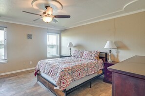 A bedroom with a bed, two bedside lamps, a ceiling fan, and a window with blinds. - Swim, Grill & Relax! Copperas Cove Family Home (Copperas Cove)