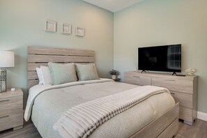 A bedroom with a bed, a TV, a nightstand, and a dresser. - Beautiful West Harwich Home: 1 Mile to Beach! (Harwich)
