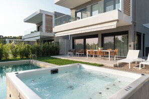 A modern house with a swimming pool and outdoor seating area.