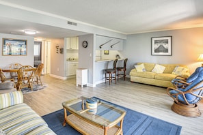 A living room with a sofa, chairs, a coffee table, and a dining area with chairs and a table. - Boat Dock, Slips & Pool! St Johns River Condo (Welaka)