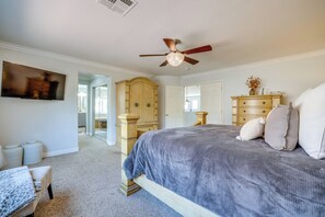 A bedroom with a bed, a television, a wardrobe, and a ceiling fan. - Spacious Vegas Retreat < 10 Mi to the Strip! (Las Vegas)