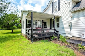A house with a porch, a small garden, and a tree. - 1 Mi to Brookville Lake, Boat Ramp! Quaint Escape (Brookville)