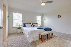 A bedroom with a bed, bedside tables, a ceiling fan, and a window with blinds. - Fenced Yard! Family Getaway, Near Texas Ski Ranch (San Marcos)