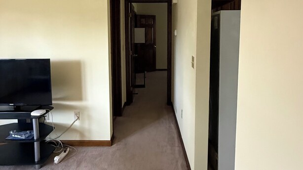 A hallway with a television, a ceiling fan, and a refrigerator. - Cozy 1-bedroom In-law apartment in cool Middletown with AC (Middletown)