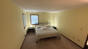 A bedroom with a bed, bedside tables, a lamp, and a window. - Cozy 1-bedroom In-law apartment in cool Middletown with AC (Middletown)