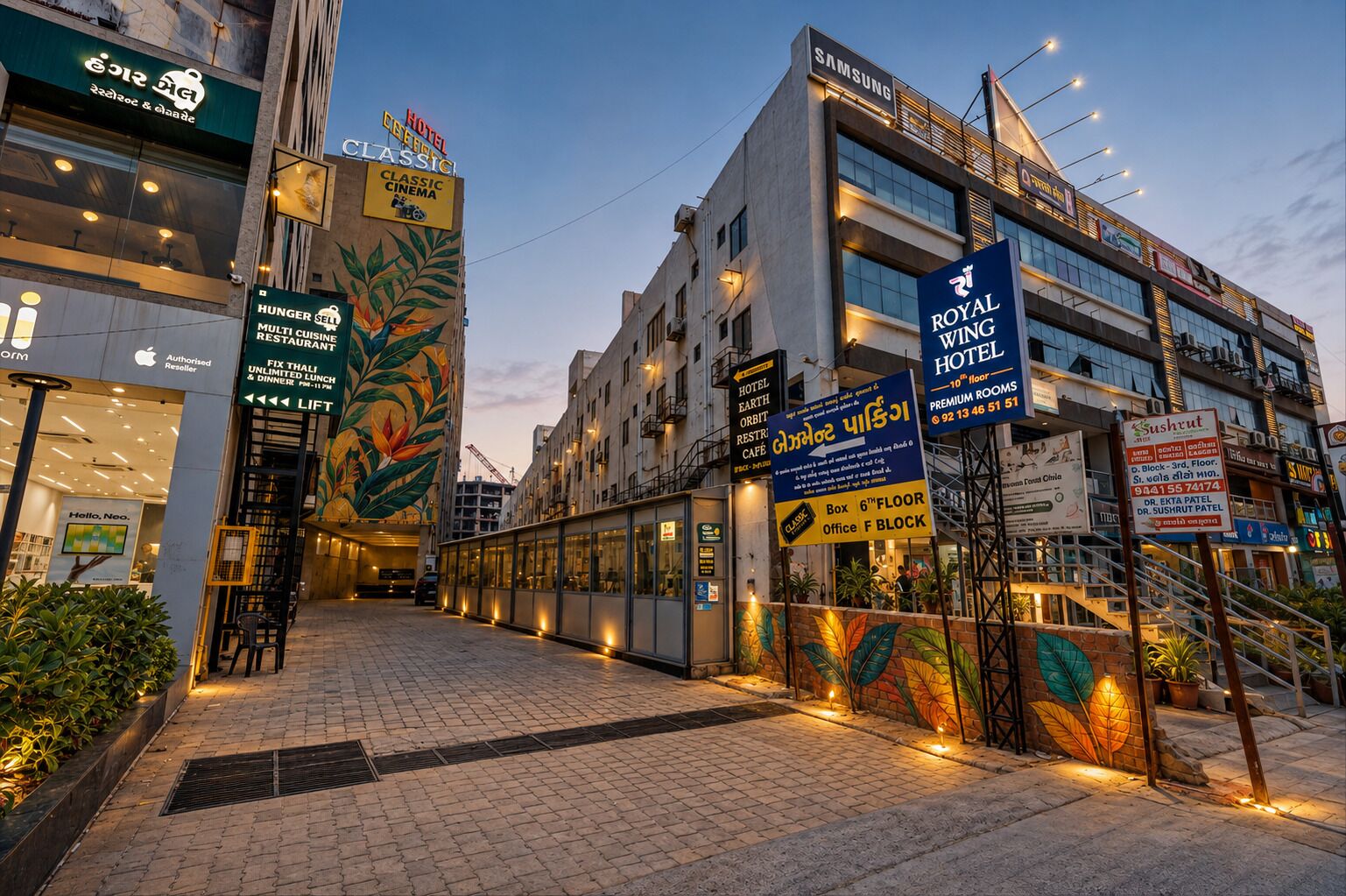 A hotel with multiple floors, a classic cinema, and a restaurant with a tropical mural.